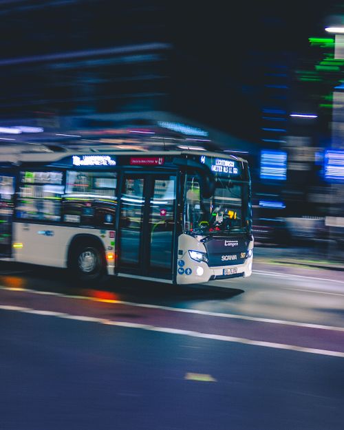 Free Dynamic motion blur of a city bus traveling fast on an urban street at night. Stock Photo