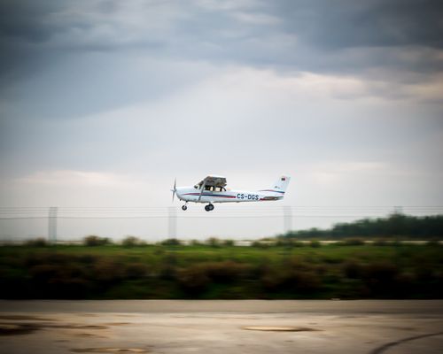 Free A small aircraft takes off from an aerodrome under a cloudy sky, showcasing aviation in action. Stock Photo