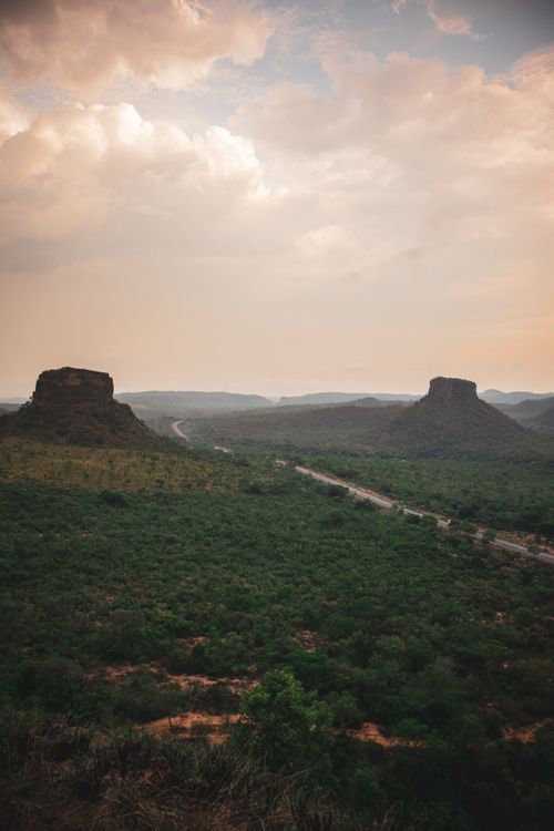 Free A breathtaking landscape of Chapada das Mesas with dramatic rock formations and lush greenery under a cloudy sky. Stock Photo