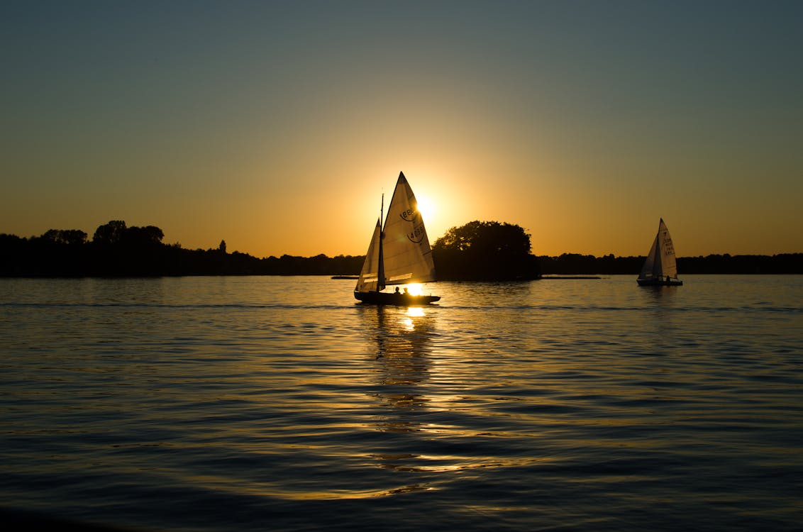 Free Sailboat on the Body of Water during Golden Houe Stock Photo