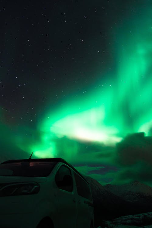 Free White Car Parked Under Aurora Borealis Stock Photo