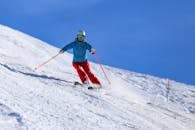 Person in Blue Jacket and Red Pants Riding on Snow Ski