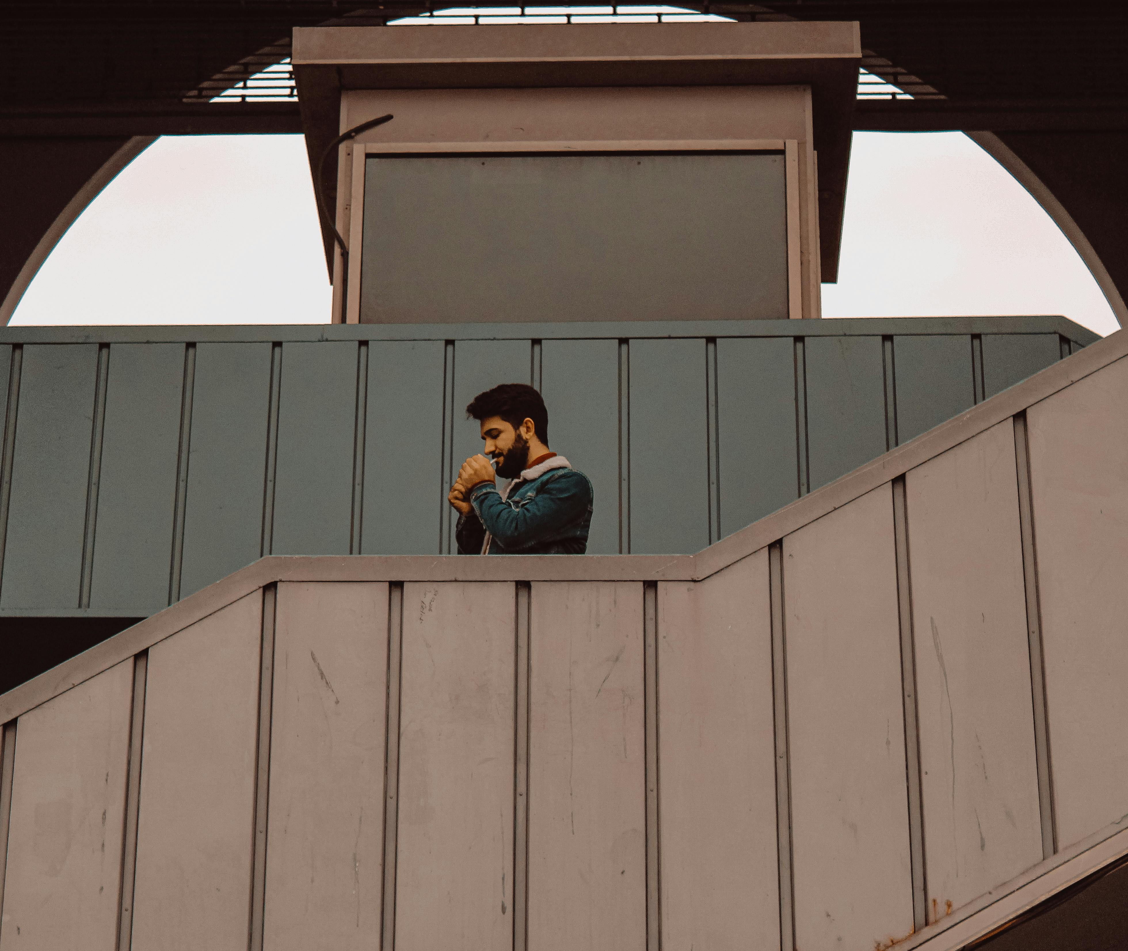Person pouring milk or cream into a cup of coffee