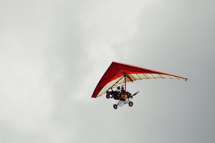 Pilots In A Powered Hang Glider In The Sky