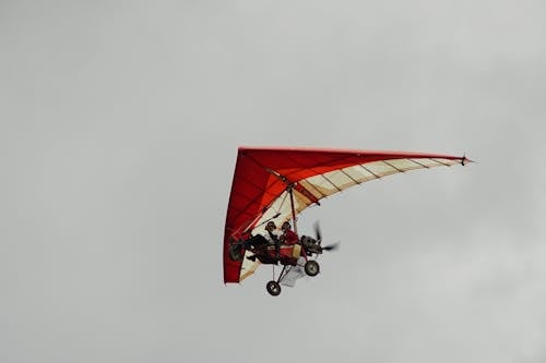 Free A Man and a Woman Flying a Powered Hang Glider Stock Photo