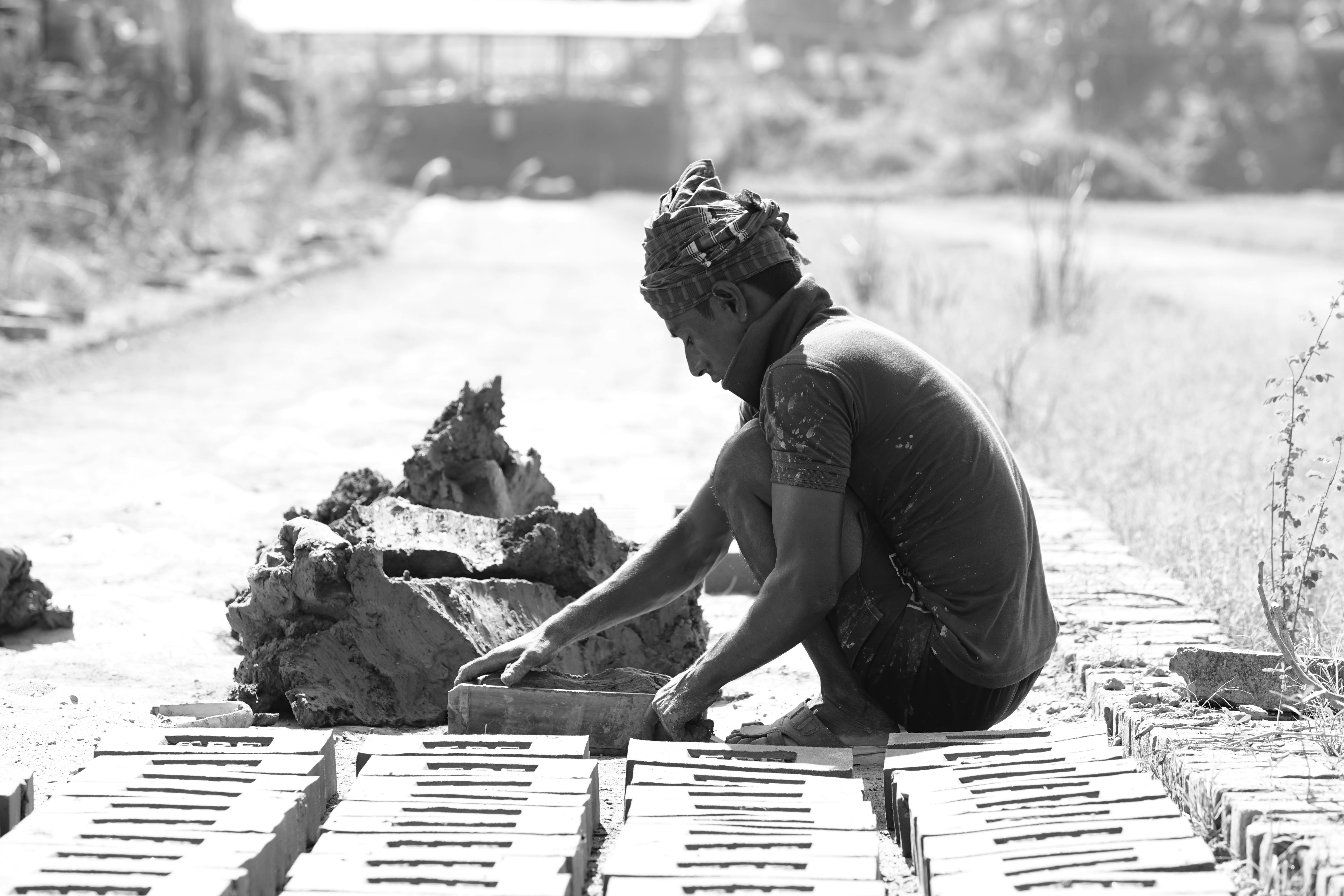 black and white photo of a man working on the road