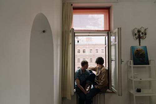 People Sitting on the Window Sill