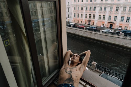 A Person Lying near the Window