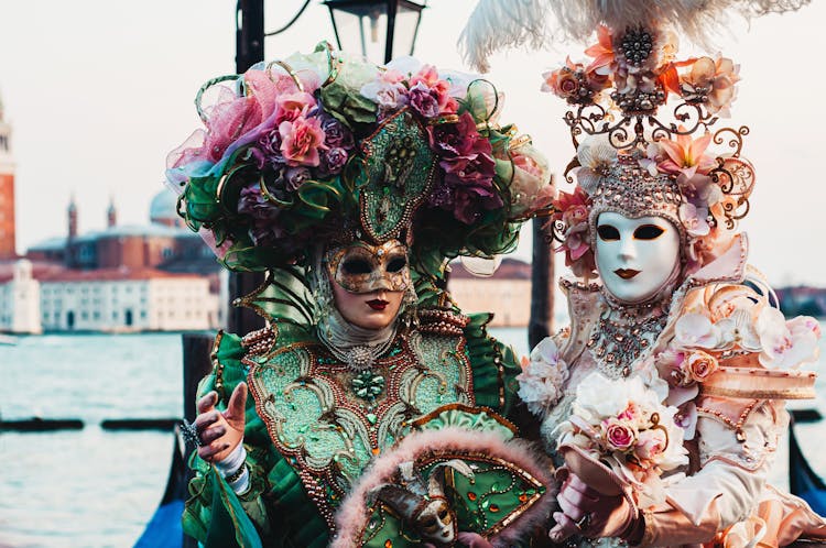 People Dressed In Elaborate Costumes For Venetian Masqueade