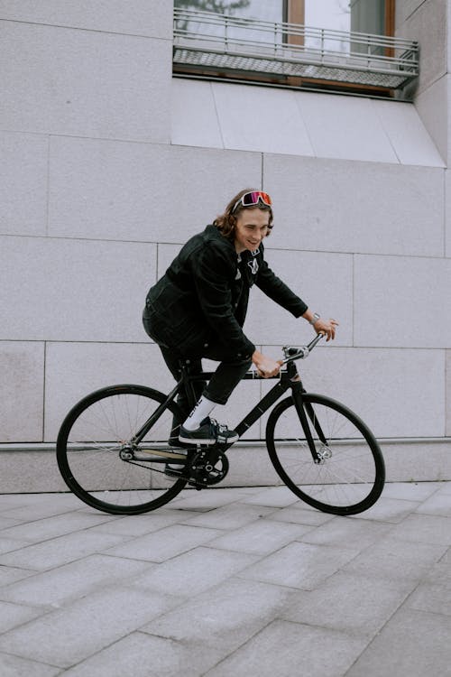 Man in Black Jacket Riding a Bicycle