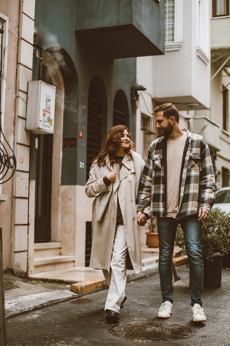 Couple Walking And Holding Hands On A City Street