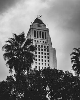 Iconic Los Angeles City Hall in a dramatic black and white skyline view.