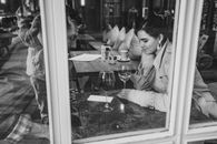 Grayscale Photo of Woman in Blazer Sitting on Chair