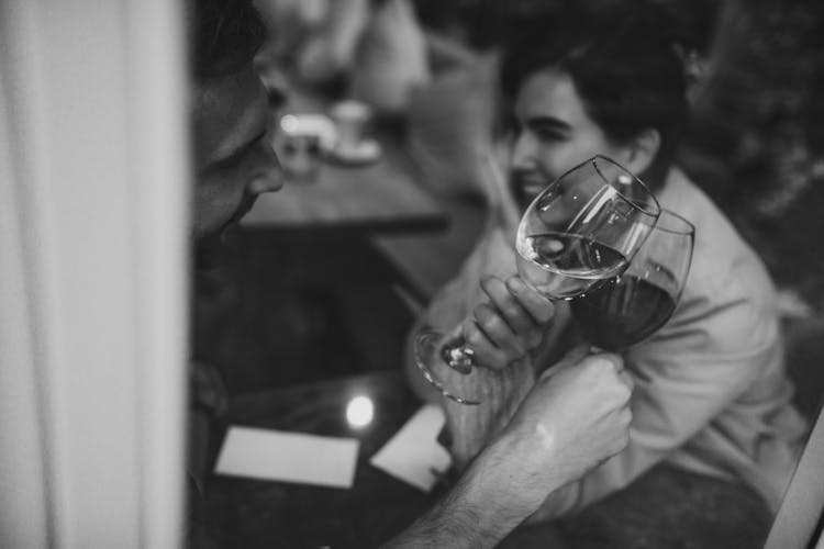 Black And White Photo Of People Toasting Wine