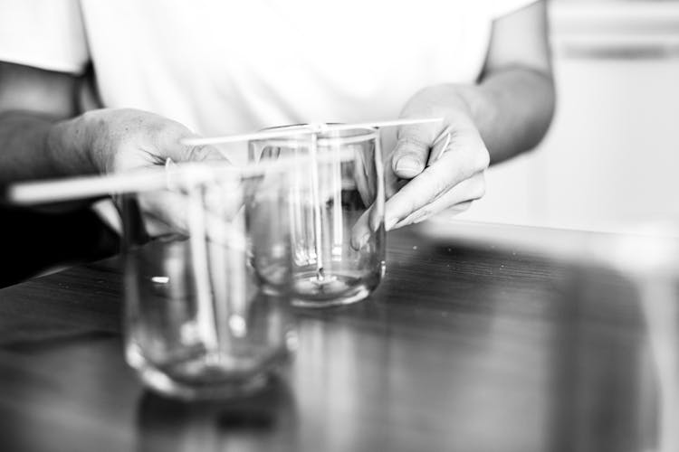 Hands Holding Glass In Black And White