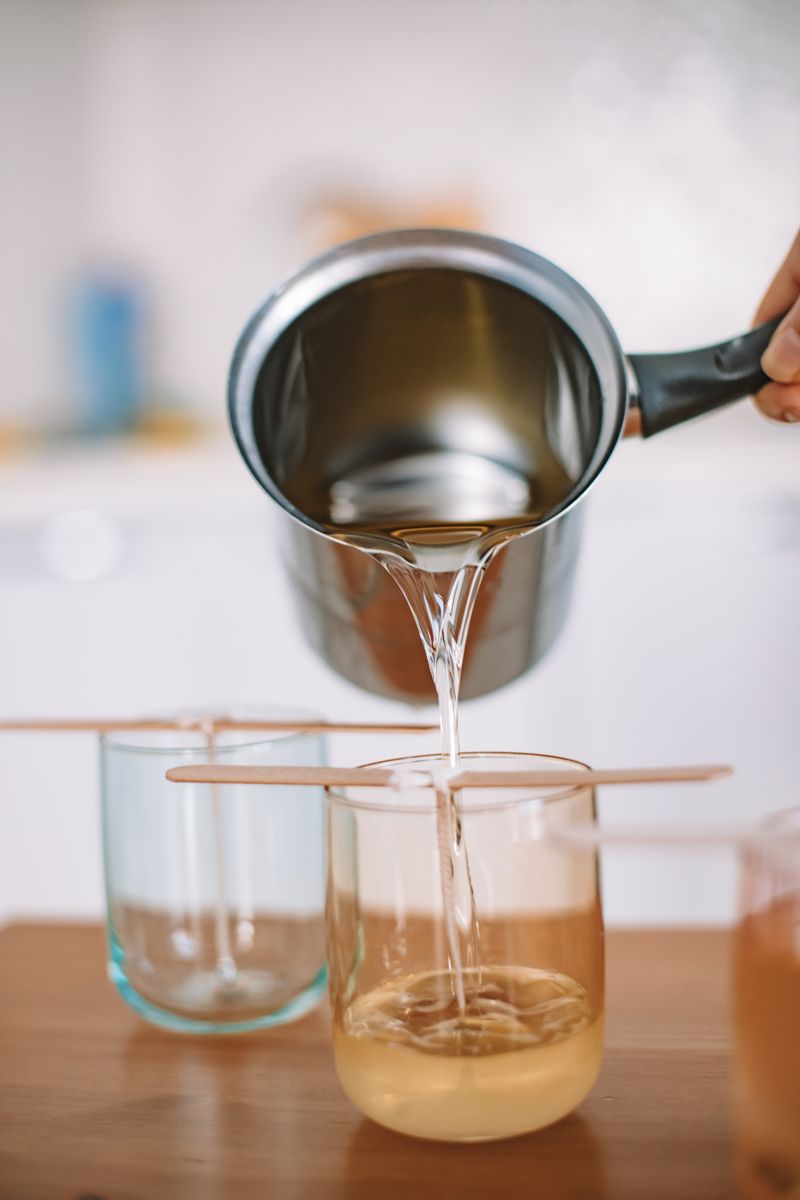 Soy wax being poured into an amber apothecary jar at the Northwind Candle Co workshop