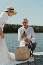 Woman in White Long Sleeve Dress Holding Brown Wicker Basket