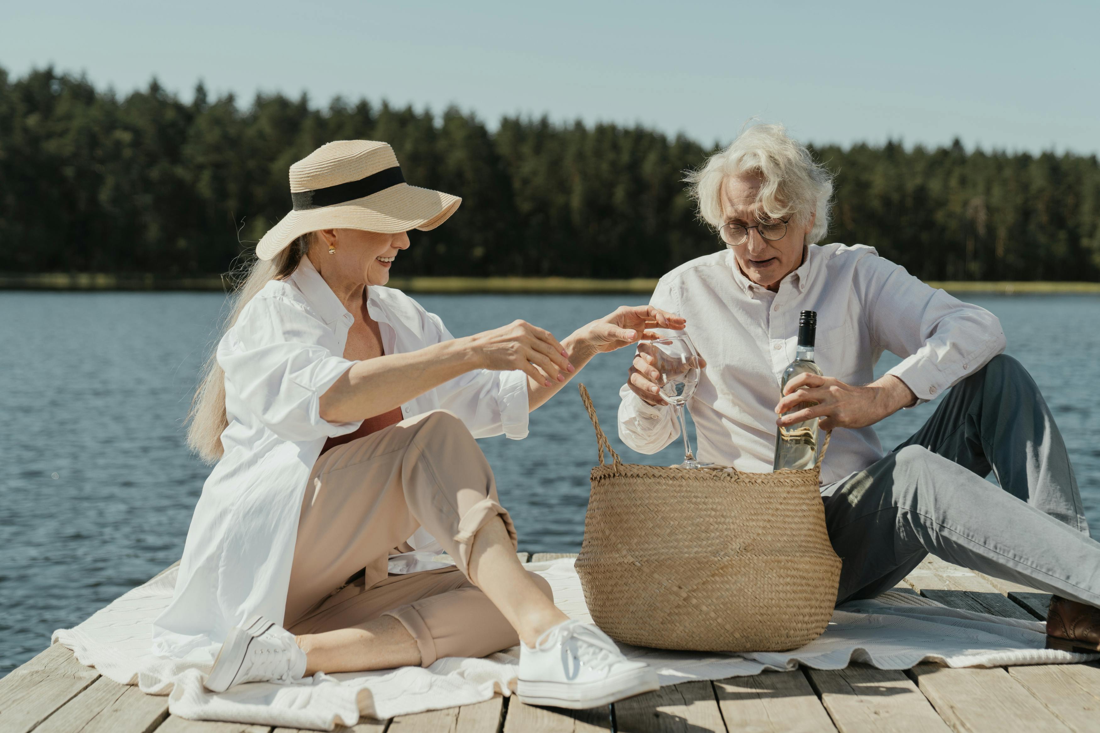 2 women sitting on brown wicker picnic basket