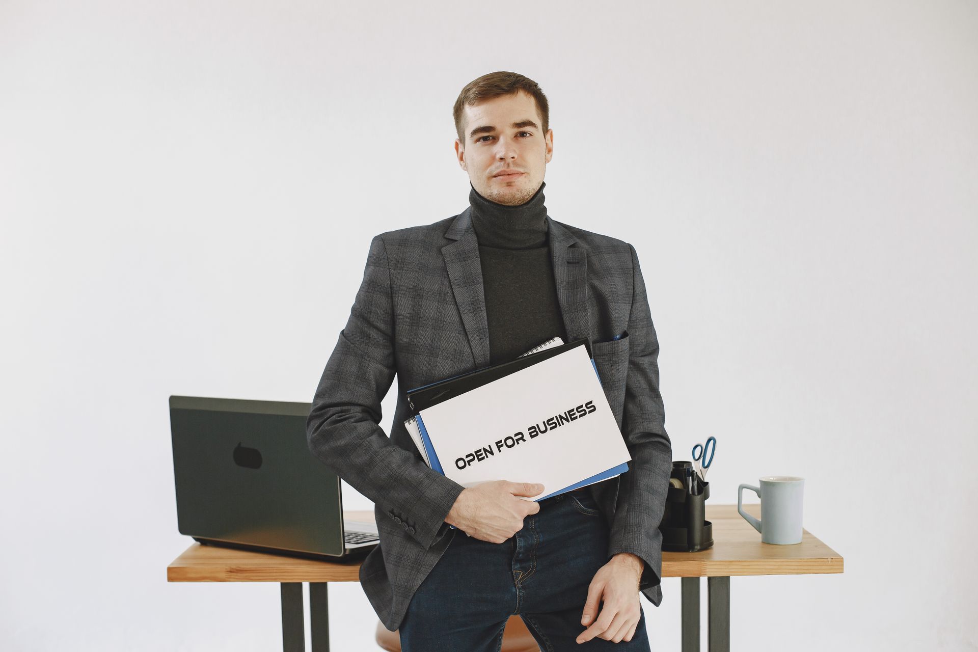 Businessman in corporate attire holding open for business sign, ready to work.
