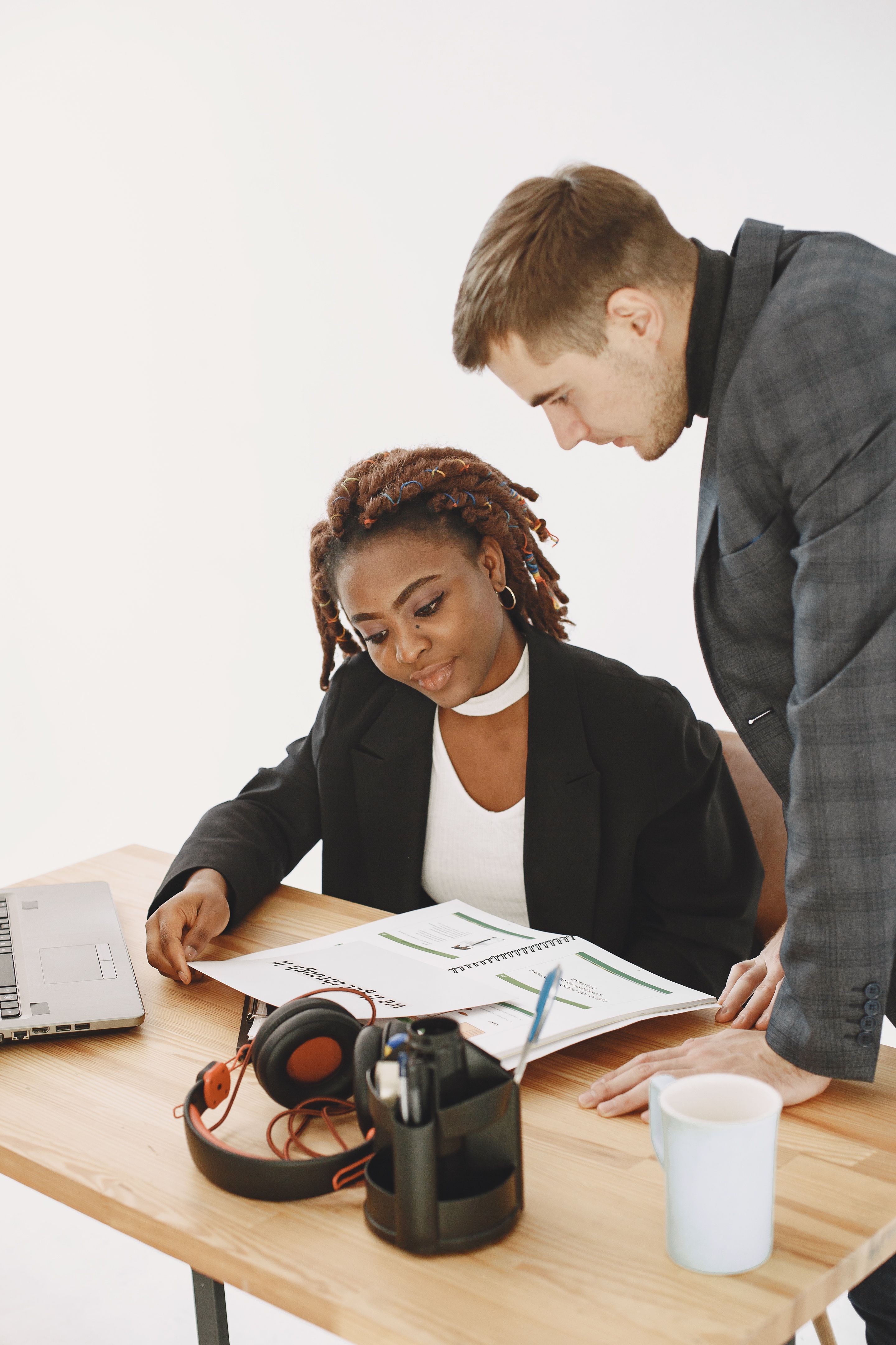 Two professionals reviewing documents together in a bright office