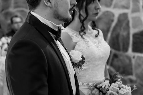 Bride and Groom Standing Next to Each Other 