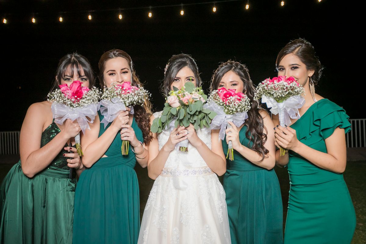 Sage green bridesmaid dress styled with bouquet and accessories