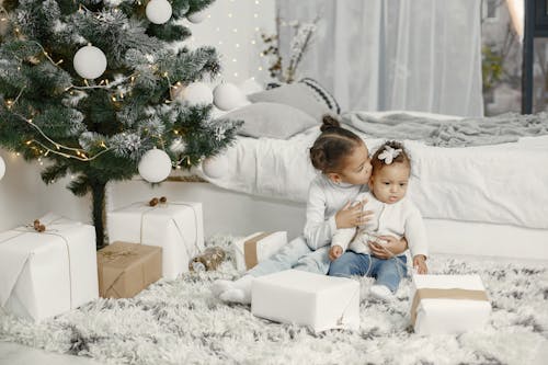 Children Sitting by Christmas Tree