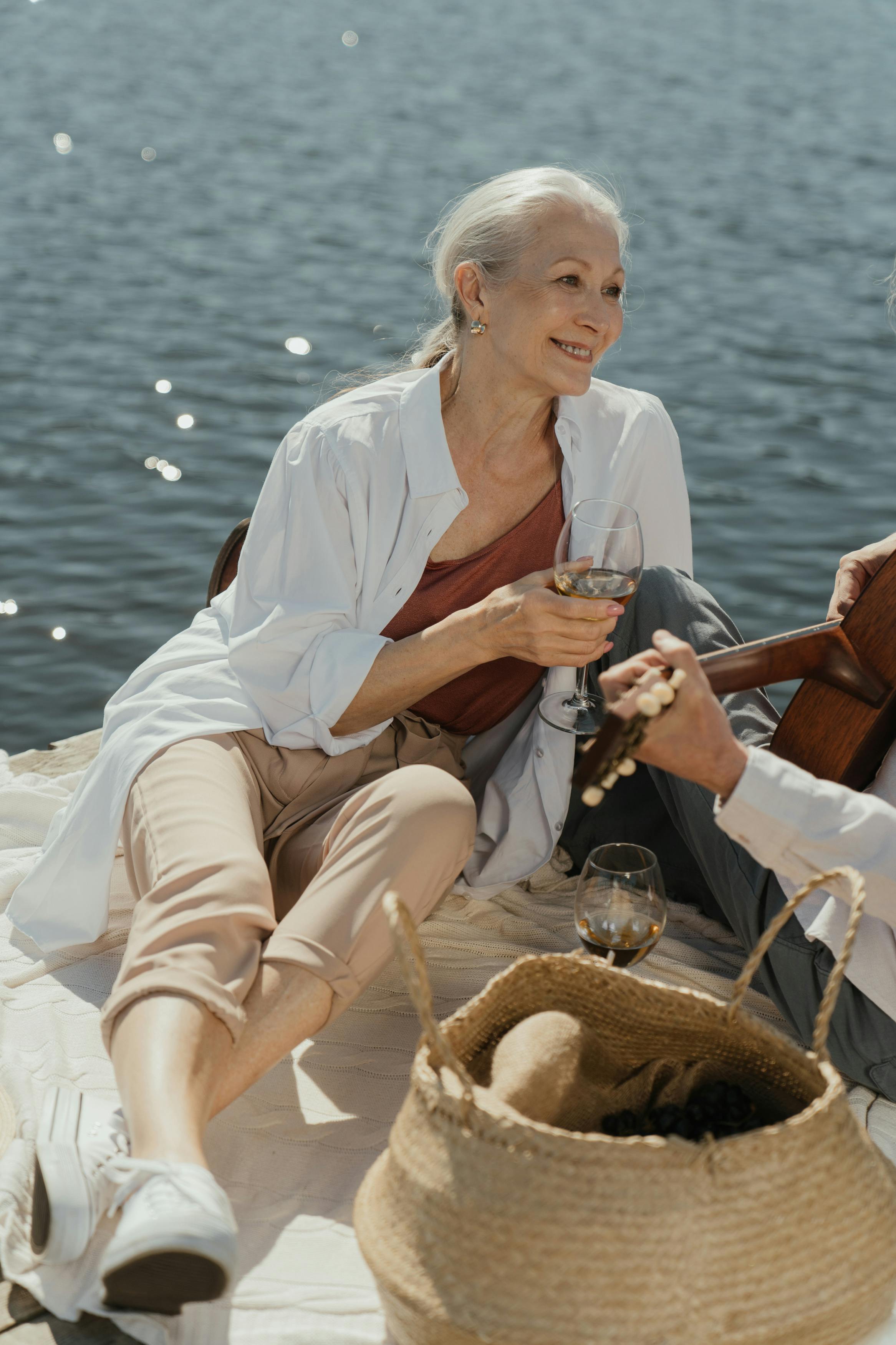 woman in white button up shirt and white pants sitting on white chair