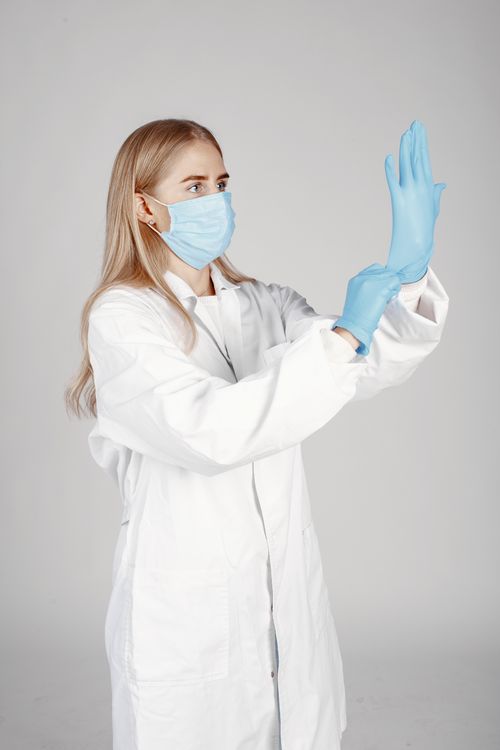 Free A healthcare worker wearing a mask and gloves emphasizes protection and hygiene. Stock Photo