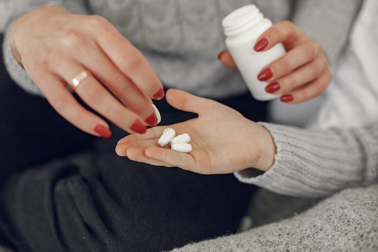 Woman Giving Pills To Man 