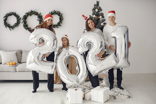 Free People Wearing Santa Hats Holding Inflatable Numbers Stock Photo