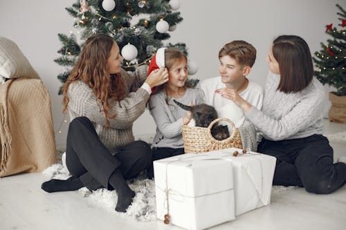 Happy Family with Children Posing Near Christmas Tree