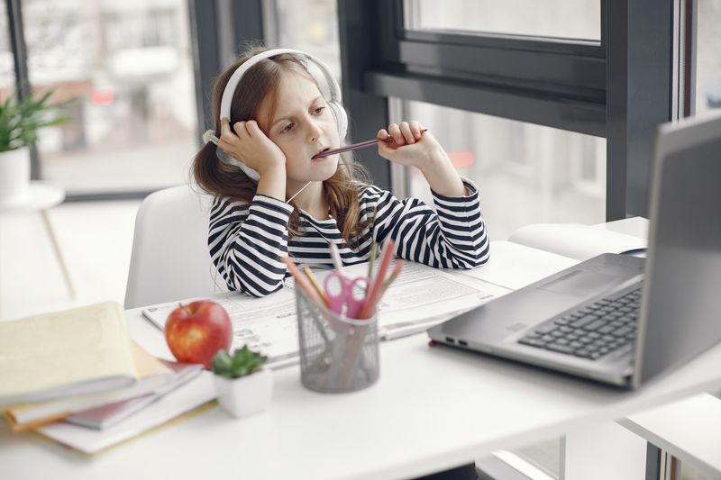 Student wearing headphones while studying online