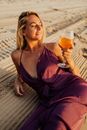 Woman in Black Spaghetti Strap Top Holding Clear Drinking Glass