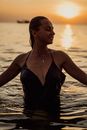 A Woman in Black Spaghetti Strap Dress on the Beach