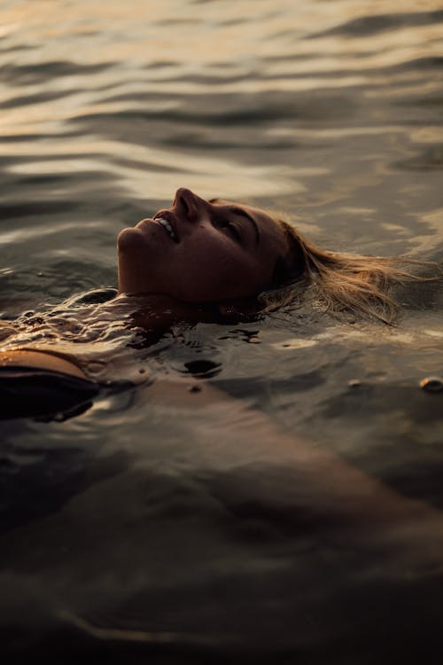 A Woman Swimming at the Beach · Free Stock Photo