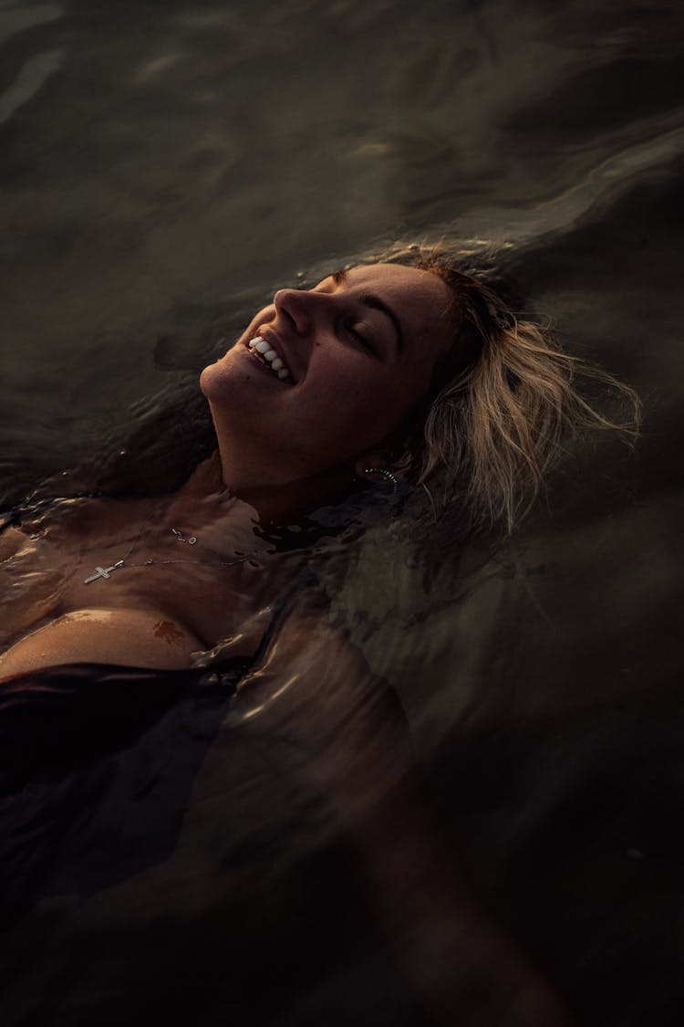 Beautiful Woman Floating On Water