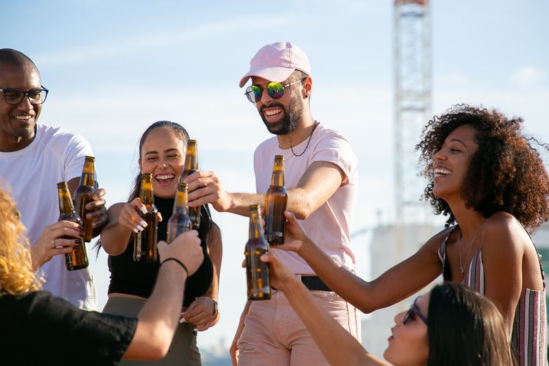 Friends toasting beer bottles
