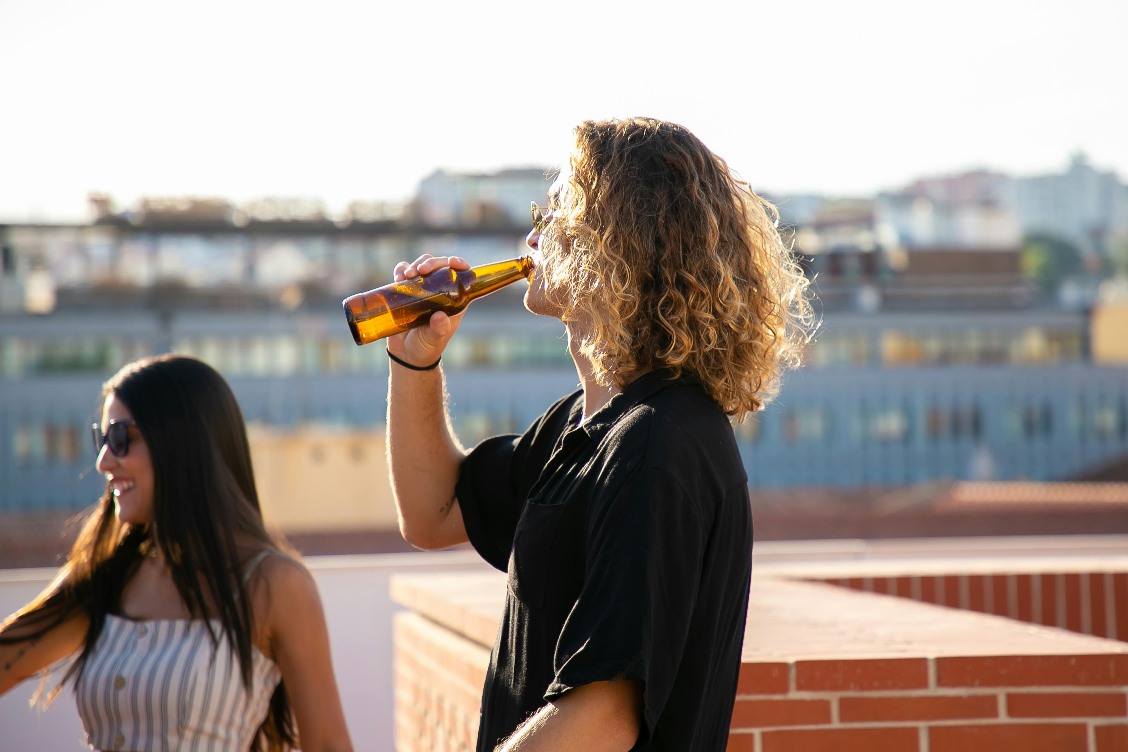 woman in black t shirt drinking beer