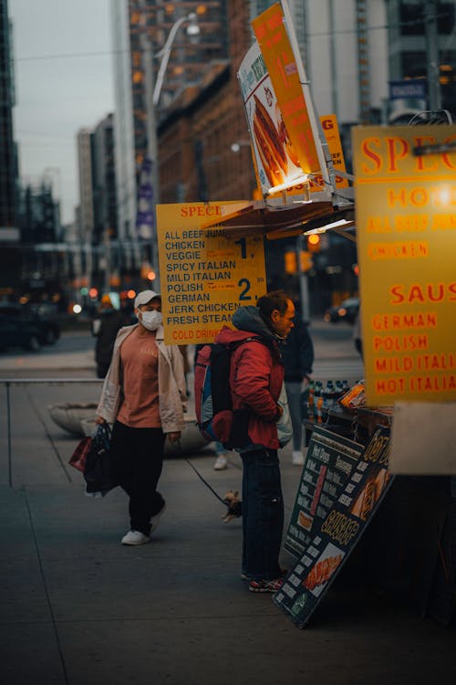 Man in Red Jacket Buying Street Food 