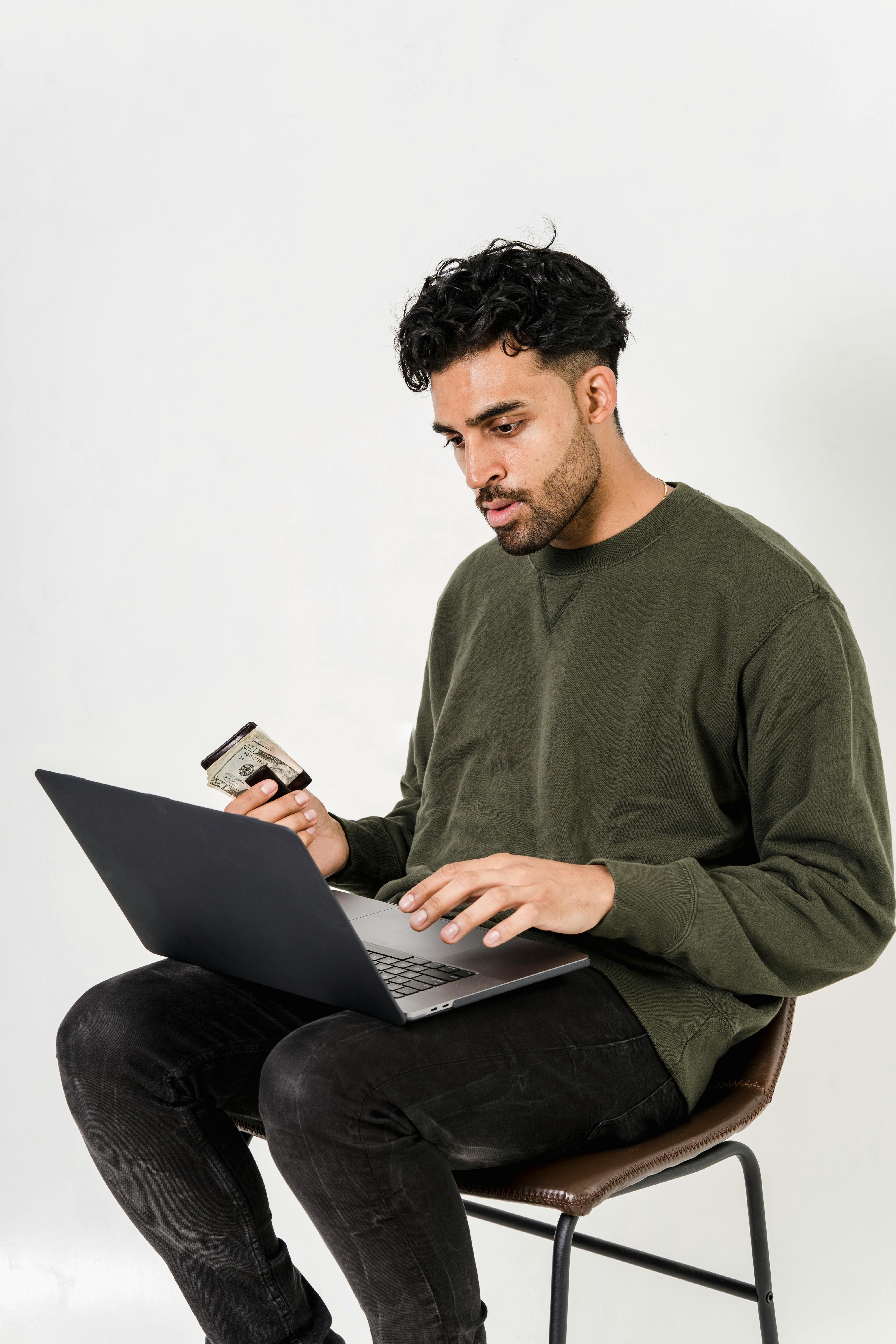 man in gray crew neck long sleeve shirt using macbook