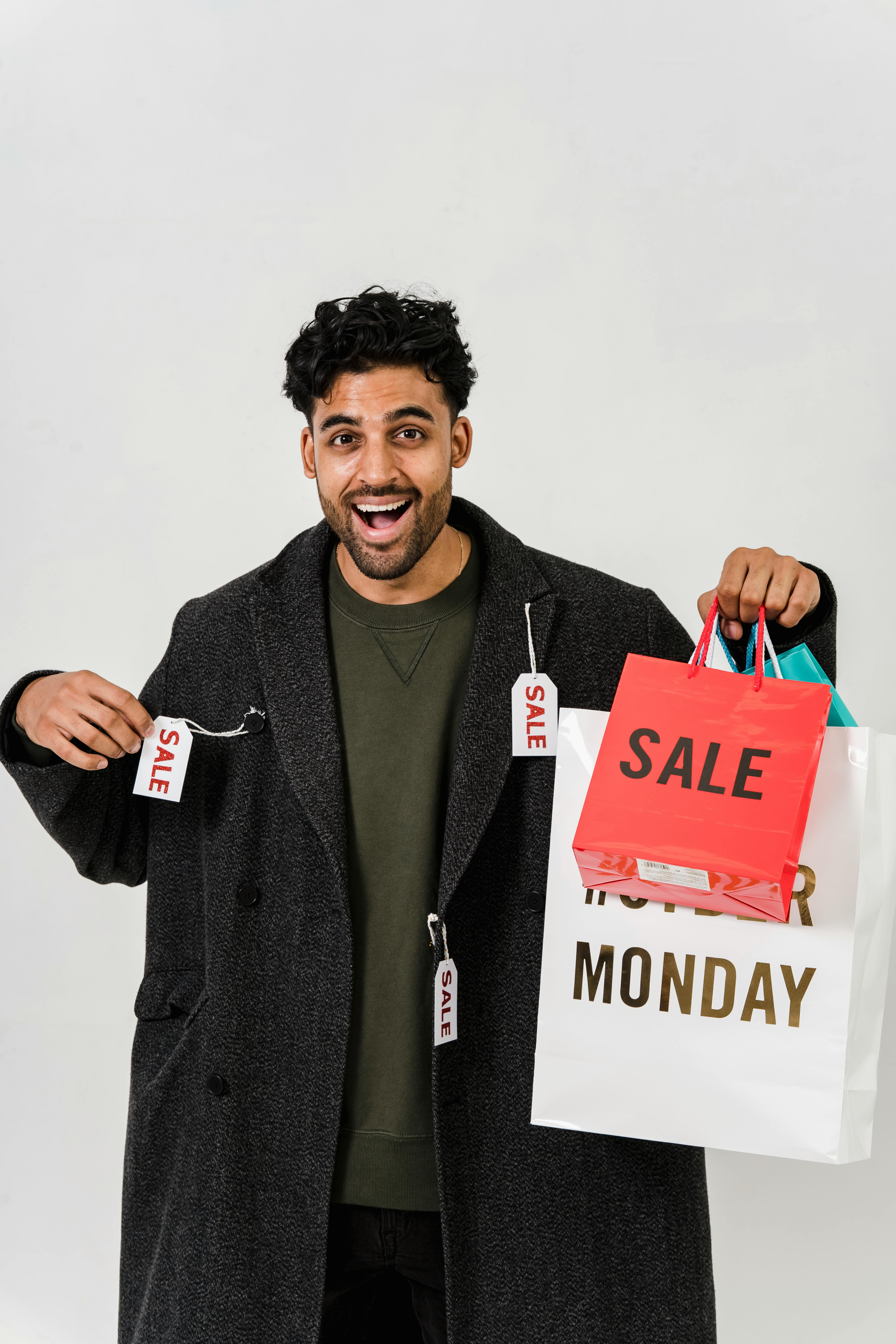 man feeling happy with his gray coat on sale