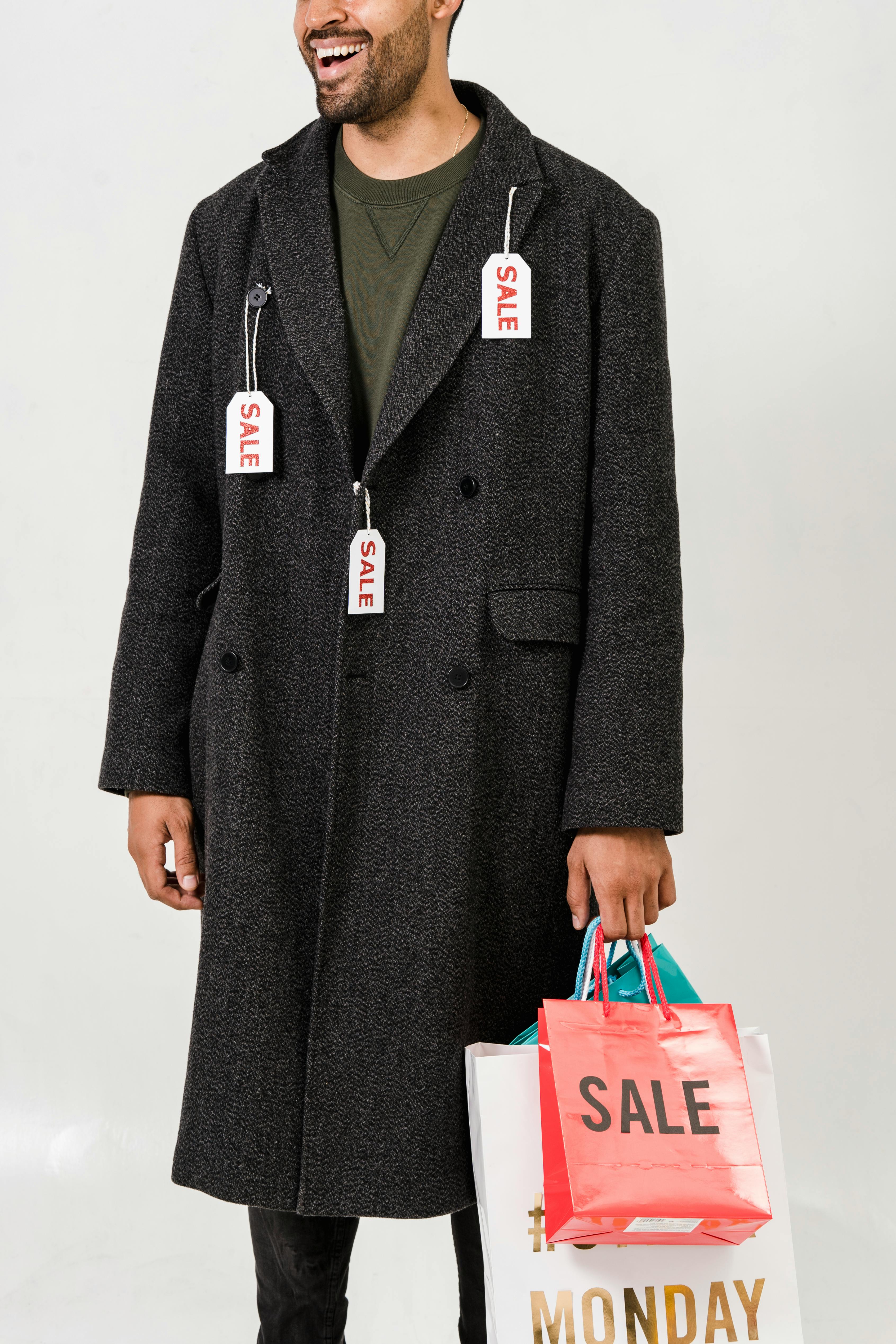man wearing gray coat with sale tags
