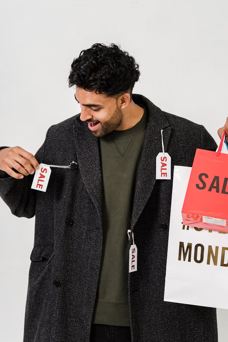 Man In Gray Blazer With Sale Tags