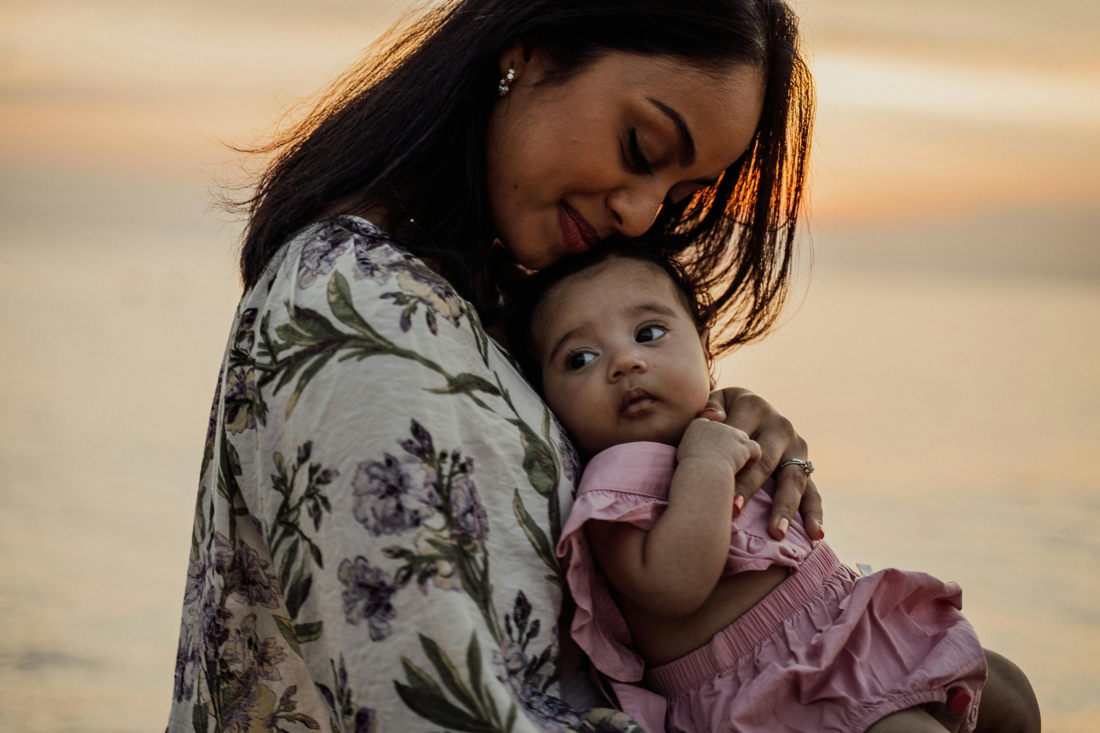 a happy mother carrying her beautiful daughter