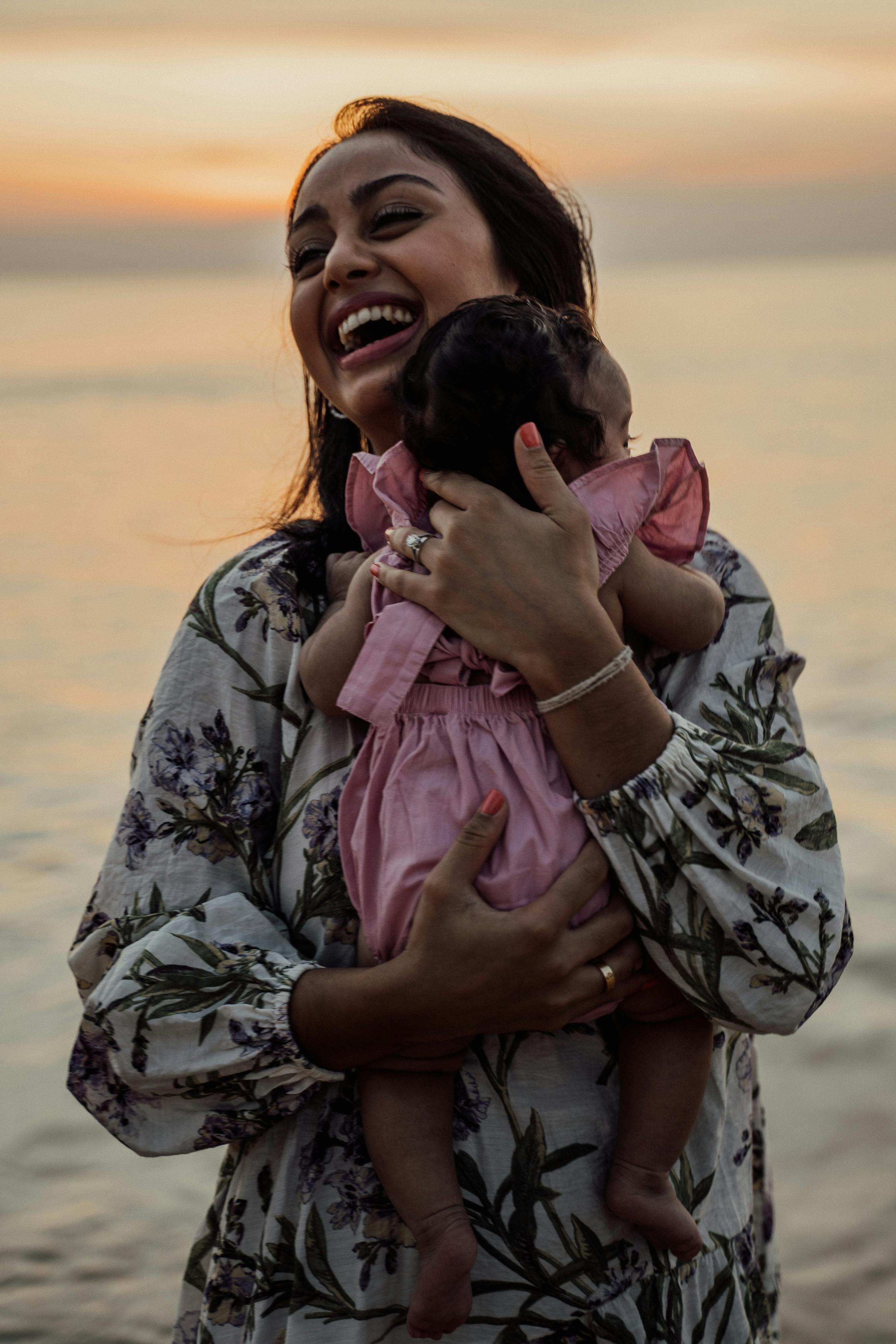 happy woman carrying a baby