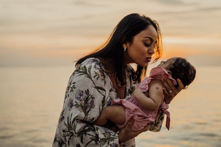 A Woman Carrying A Baby