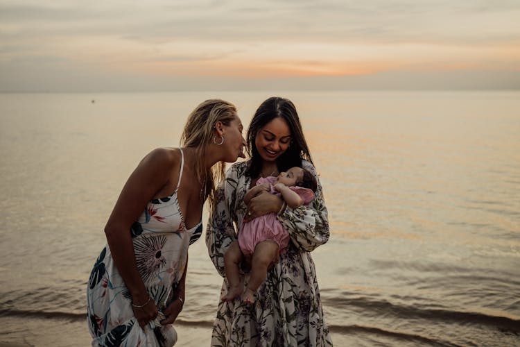 A Woman Carrying A Baby