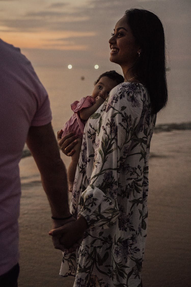 A Woman Carrying A Baby