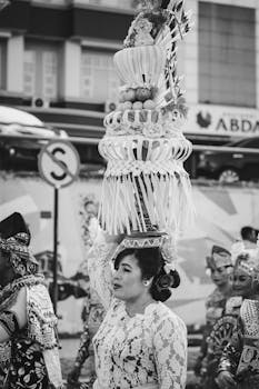 A woman in traditional attire participates in a festive parade in Kepulauan Riau, Indonesia.